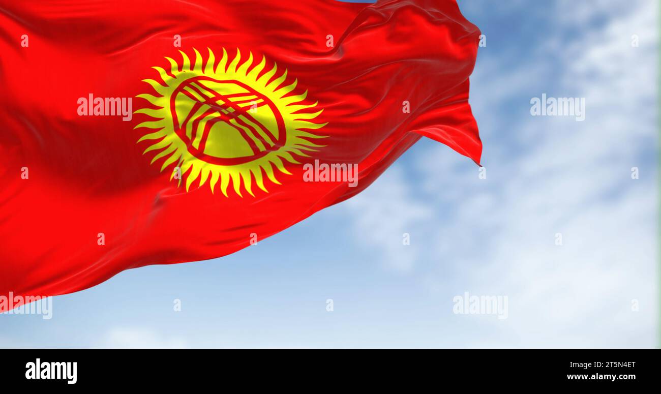 Kirgisistans Nationalflagge winkt an einem klaren Tag. Rotes Feld, gelbe Sonne mit 40 Strahlen, überkreuzte Dreifachlatten symbolisieren die kirgisische Jurte. 3D-Darstellung Stockfoto
