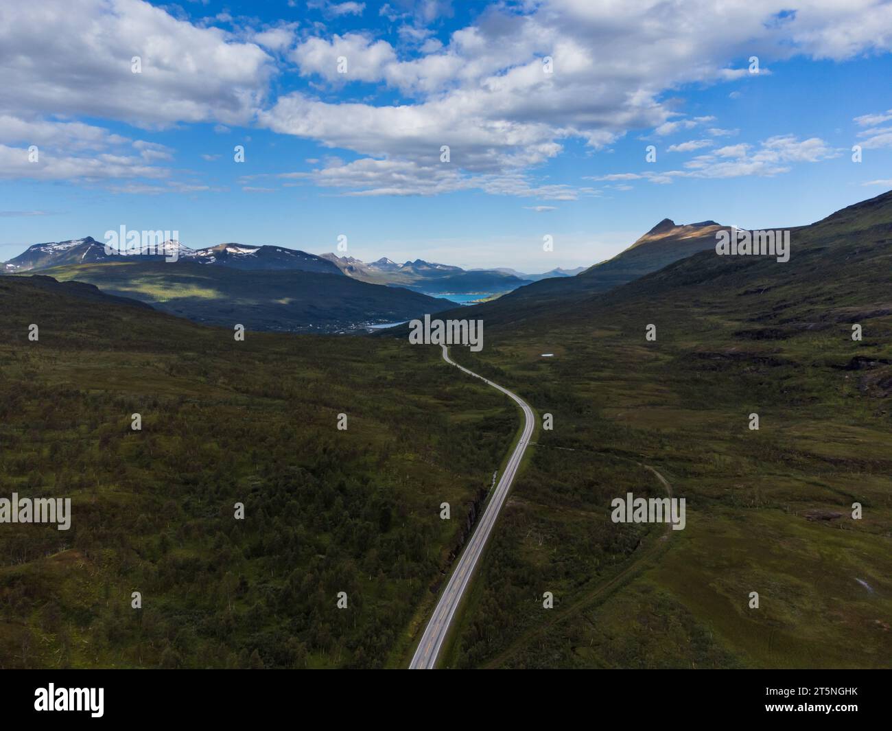 Gewundene Straße in einem Hochtal in Norwegen, Wolken und hohe Berge. Taiga und arktisches Gefühl. Stockfoto