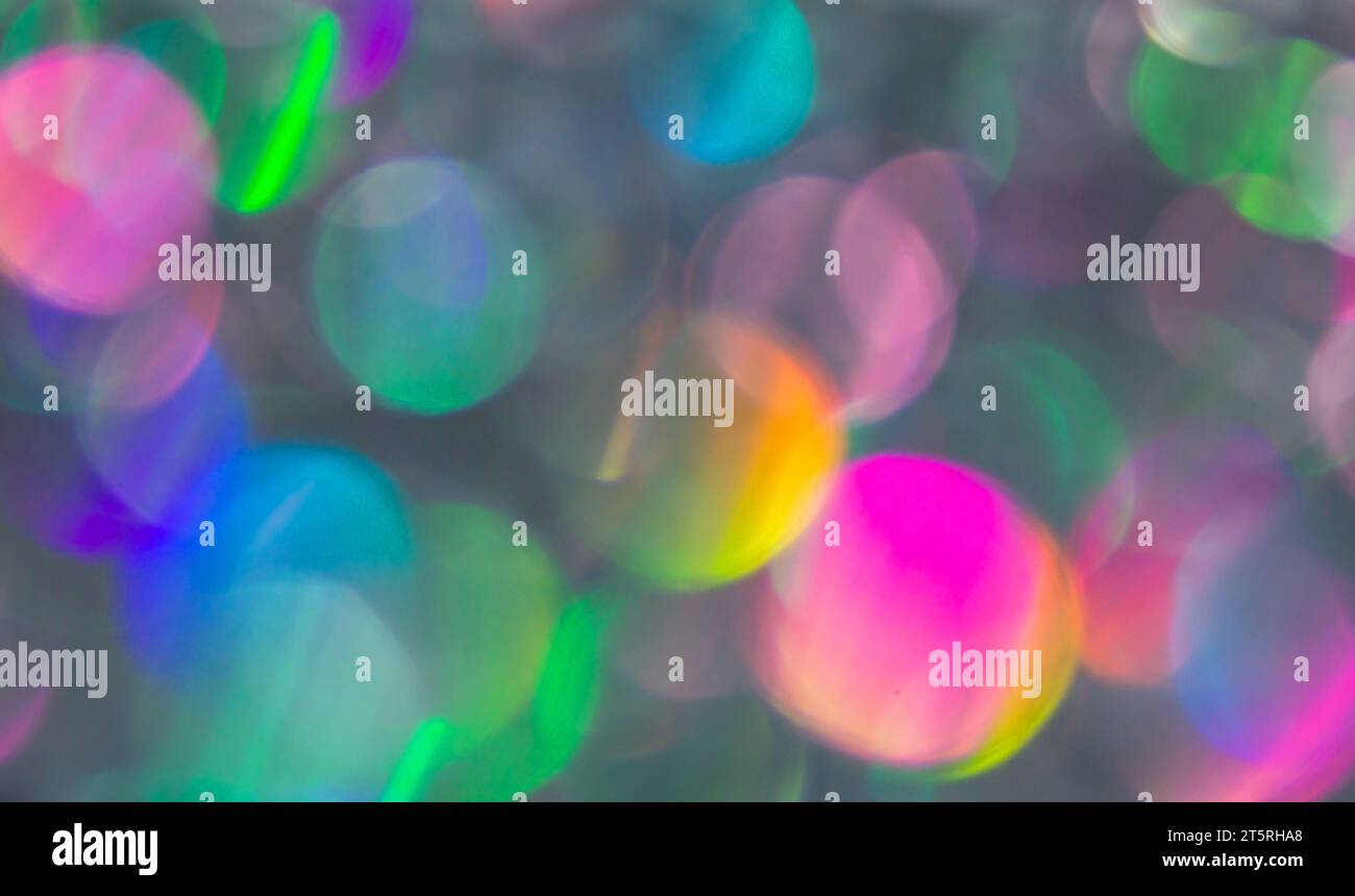 Abstrakte farbenfrohe Weihnachtslichter in Violett- oder rosa Glitzer. Weihnachtlicher Hintergrund. Unfokussierte Bokeh-Partikel. Vorlage für Design. Stockfoto