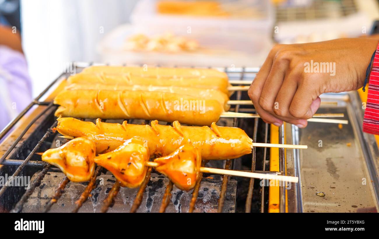 Würstchen, Fischbällchen, gegrillt mit heißer Holzkohle Stockfoto