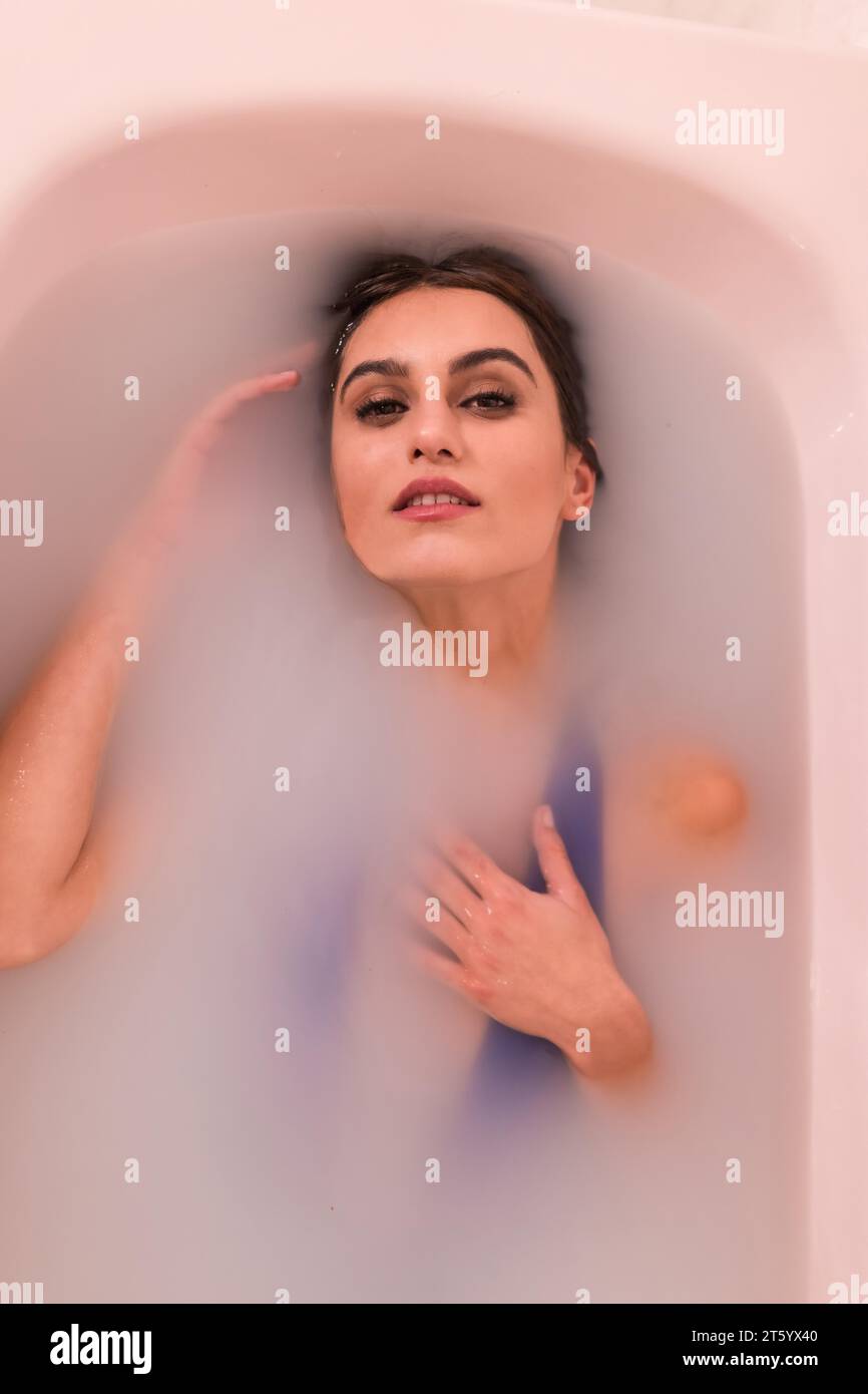 Künstlerisches Porträt der Draufsicht einer Schönheitsfrau im Milchbad Stockfoto