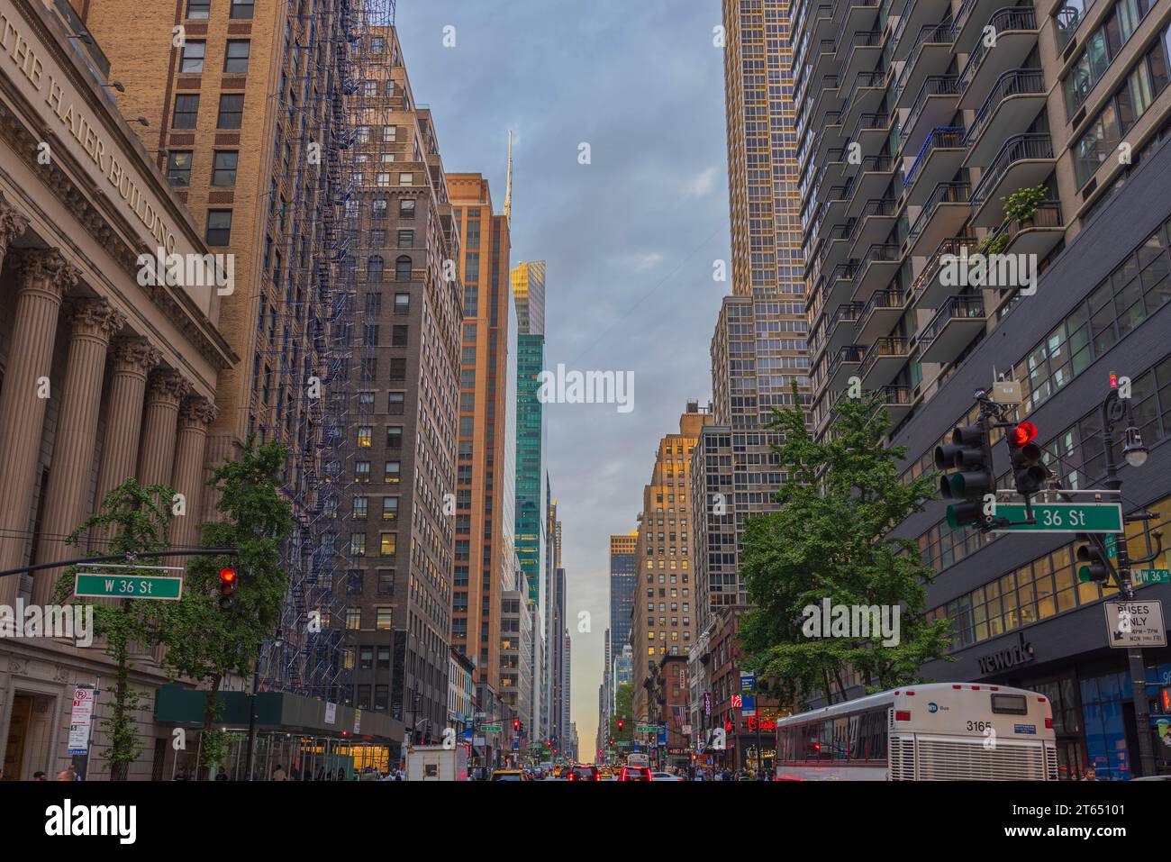 Blick auf die 36th Street in Manhattan mit Wolkenkratzern und geschäftigem Transport, vor dem Hintergrund des blauen Himmels mit weißen Wolken. New York. USA. Stockfoto
