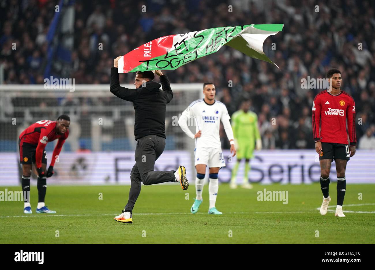 Während des Spiels der UEFA Champions League Gruppe A im Parken-Stadion in Kopenhagen schwingt ein Eindringling eine palästinensische Flagge. Bilddatum: Mittwoch, 8. November 2023. Stockfoto