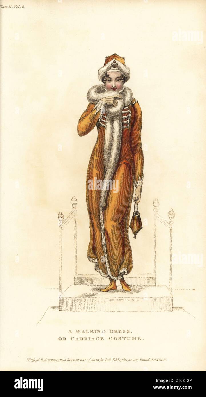 Regency Frau in Promenade oder Kutschenkostüm. Militärmantel oder Pelisse aus bernsteinfarbenem Samt mit Astracan-Fell, spanischen Manschetten, hohem geriffelten Kragen, passendem Spott. Algerine Helmkappe. Platte 11, Februar 1 1811. Handkolorierter Kupferstich von Thomas Uwins aus Rudolph Ackermanns Repository of Arts, London. Stockfoto