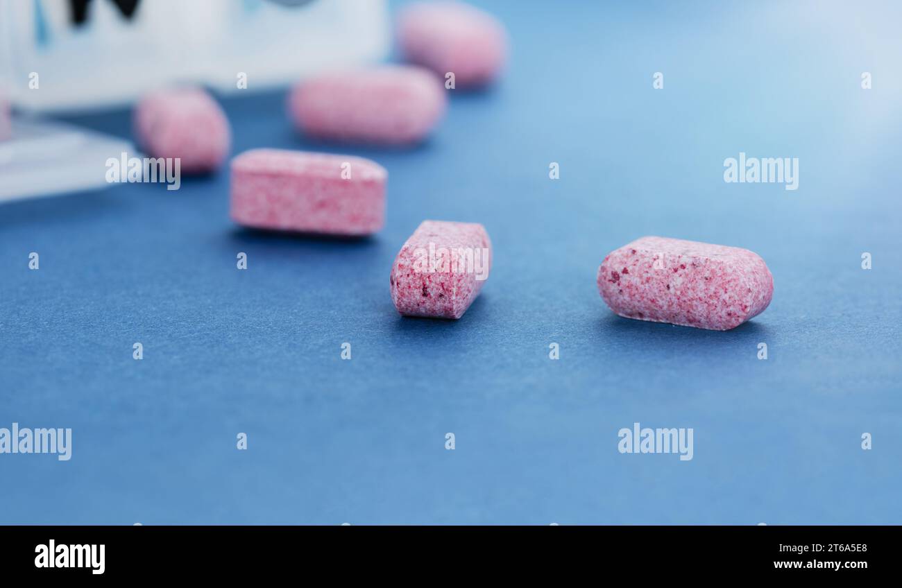 Konzeptuelles Bild eines Pillen-Organizers mit Pillen auf einem blauen Tisch. Stockfoto