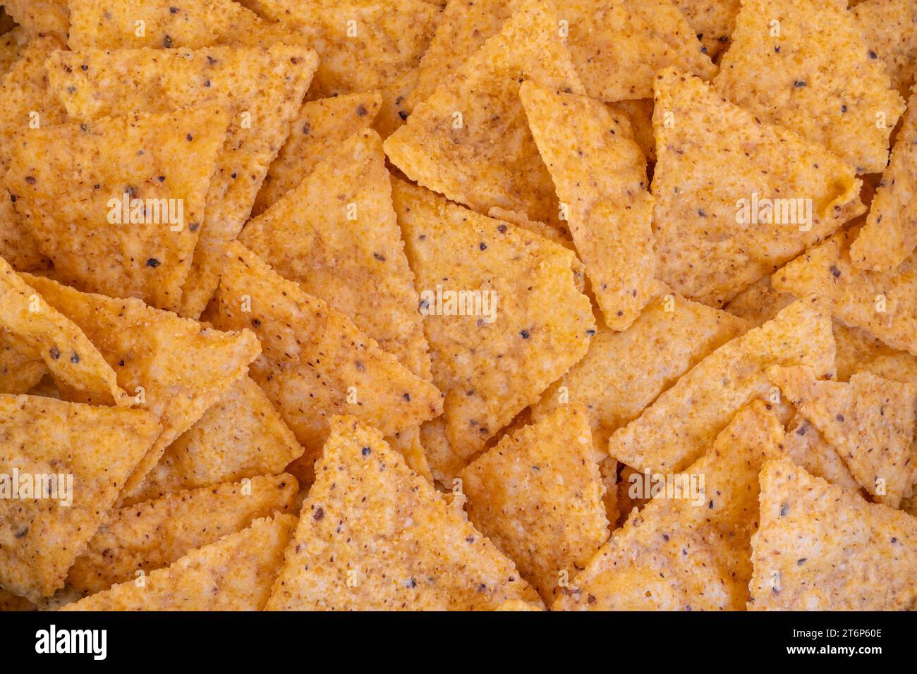 Haufen mexikanischer Nachos oder Tortilla-Chips als Texturhintergrund Stockfoto
