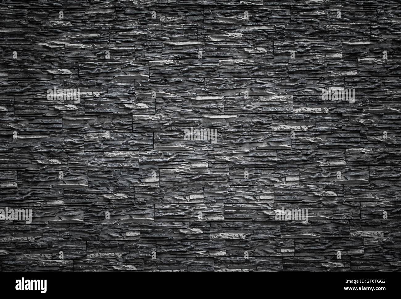 Schwarze Ziegelwand, dunkler Hintergrund für Design Stockfoto