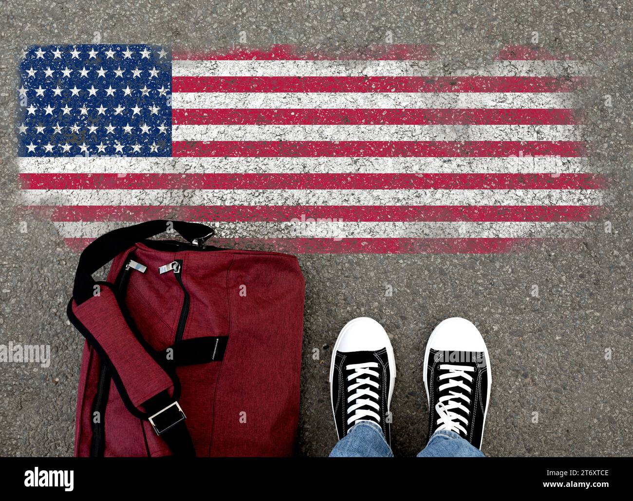 Einwanderung. Mann mit Tasche auf Asphalt, nahe der Flagge der USA, Blick von oben Stockfoto