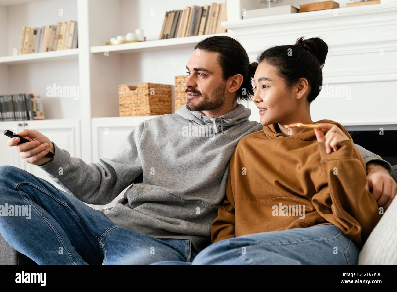 Paare schauen fernsehen essen Stockfoto