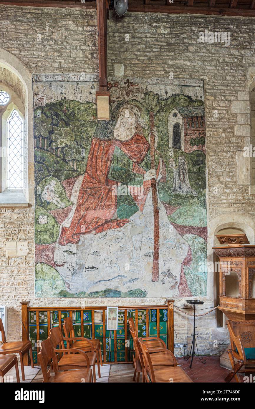 Wandgemälde von St. Christopher aus dem 14. Jahrhundert in der Kirche St. Mary Magdalene aus dem 12. Jahrhundert im Cotswold-Dorf Baunton, Gloucestershire, Großbritannien Stockfoto