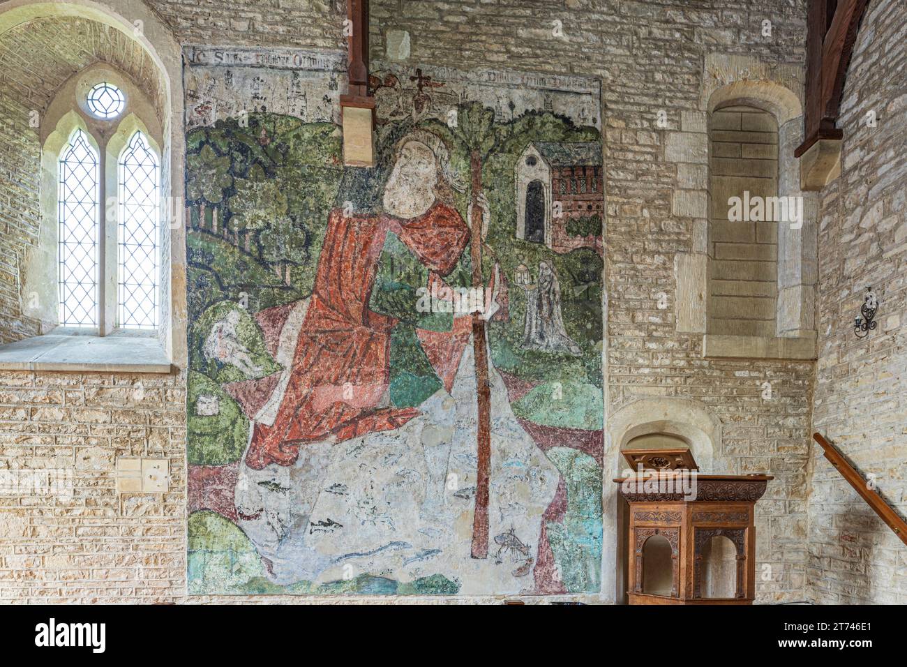 Wandgemälde von St. Christopher aus dem 14. Jahrhundert in der Kirche St. Mary Magdalene aus dem 12. Jahrhundert im Cotswold-Dorf Baunton, Gloucestershire, Großbritannien Stockfoto
