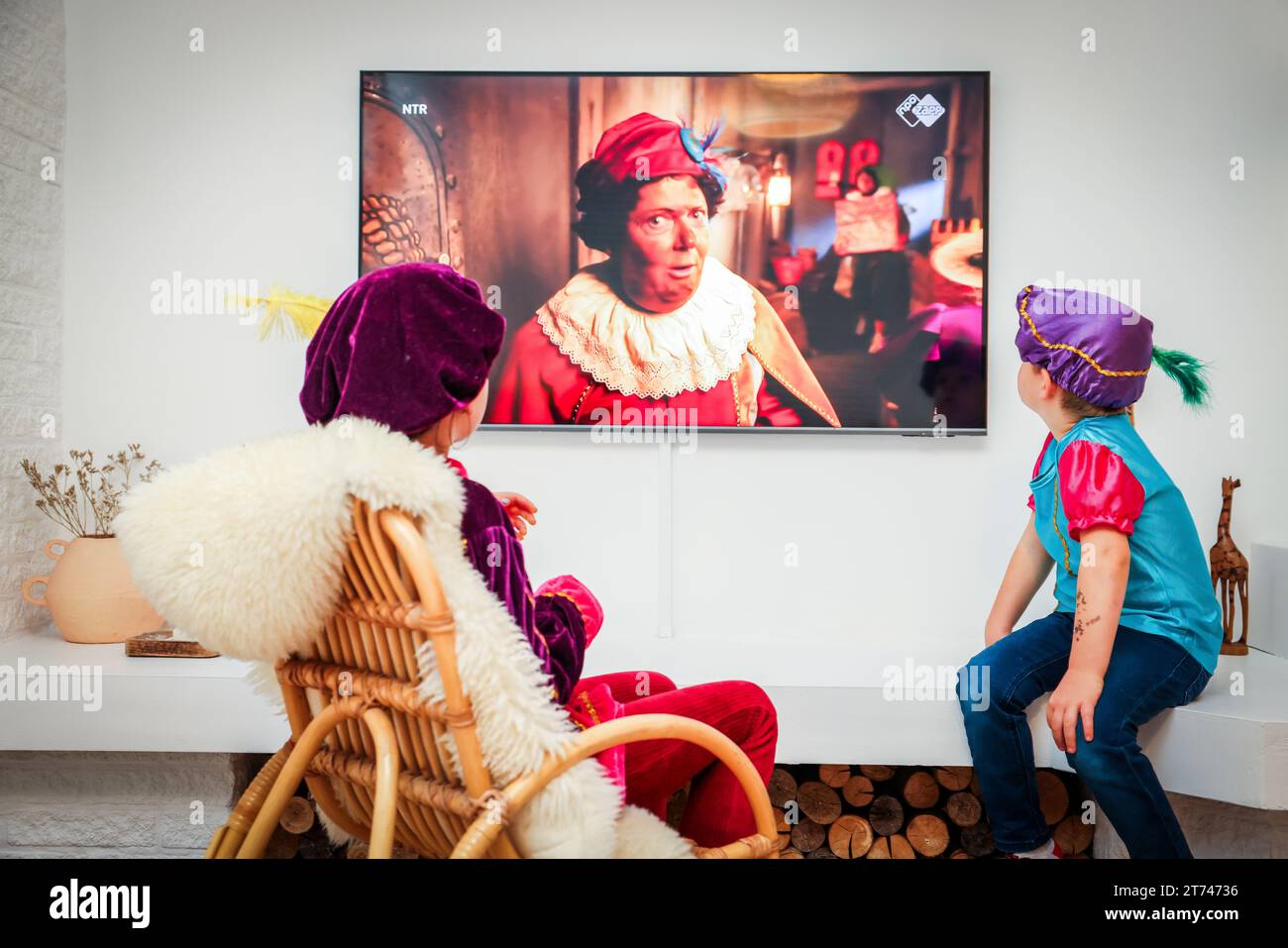 ILLUSTRATION - Kinder sehen die Sinterklaas-Nachrichten im Fernsehen im Wohnzimmer, die wieder angefangen haben. ANP JEFFREY GROENEWEG niederlande Out - belgien Out Stockfoto
