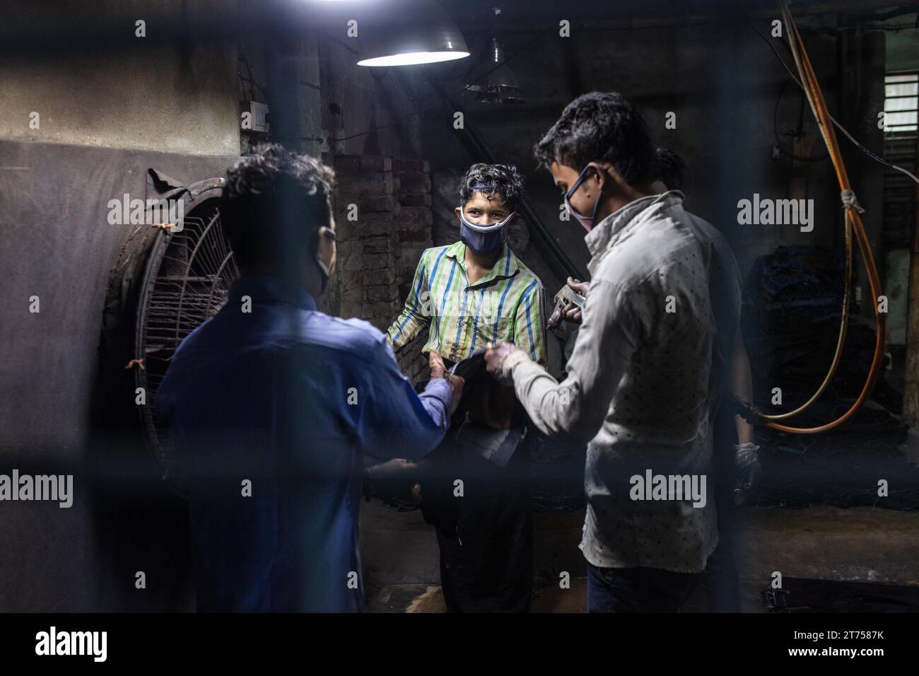 Arbeiter, die Jeans färben, in einer Textilfabrik in Dhaka, Bangladesch Stockfoto