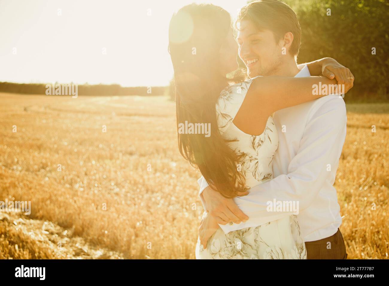 Lächeln, paar umarmt in einem Feld Stockfoto