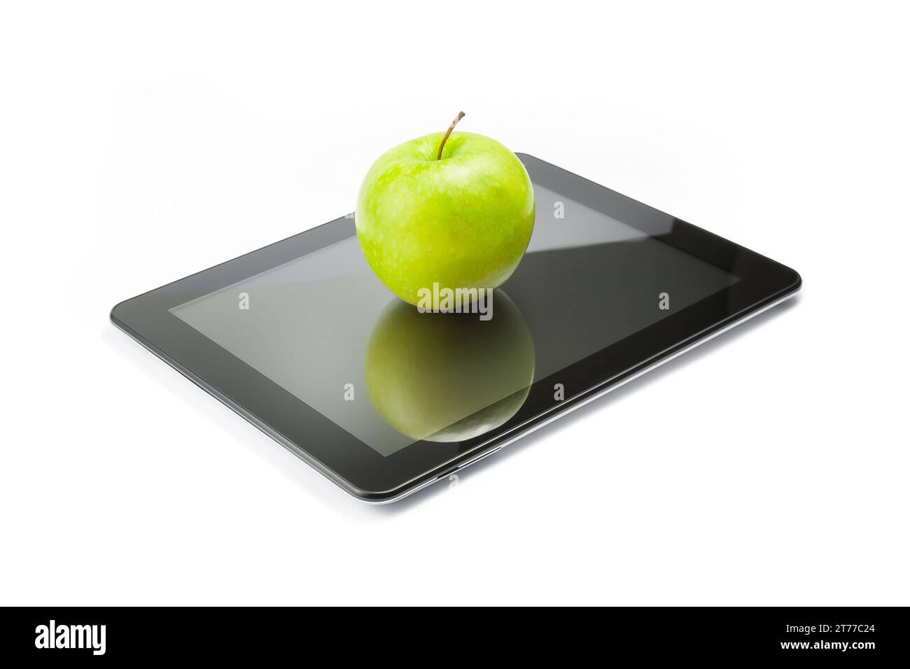 Grüner Apfel auf digitalem Tablet-pc auf weißem Hintergrund, Konzept zum Lernen neuer Technologien Stockfoto