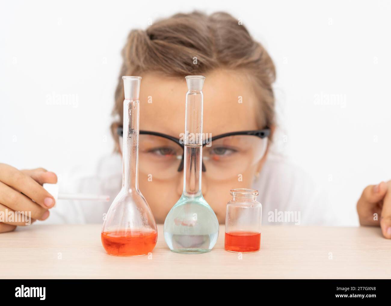 Mädchen macht Chemieexperimente mit Reagenzgläsern Stockfoto