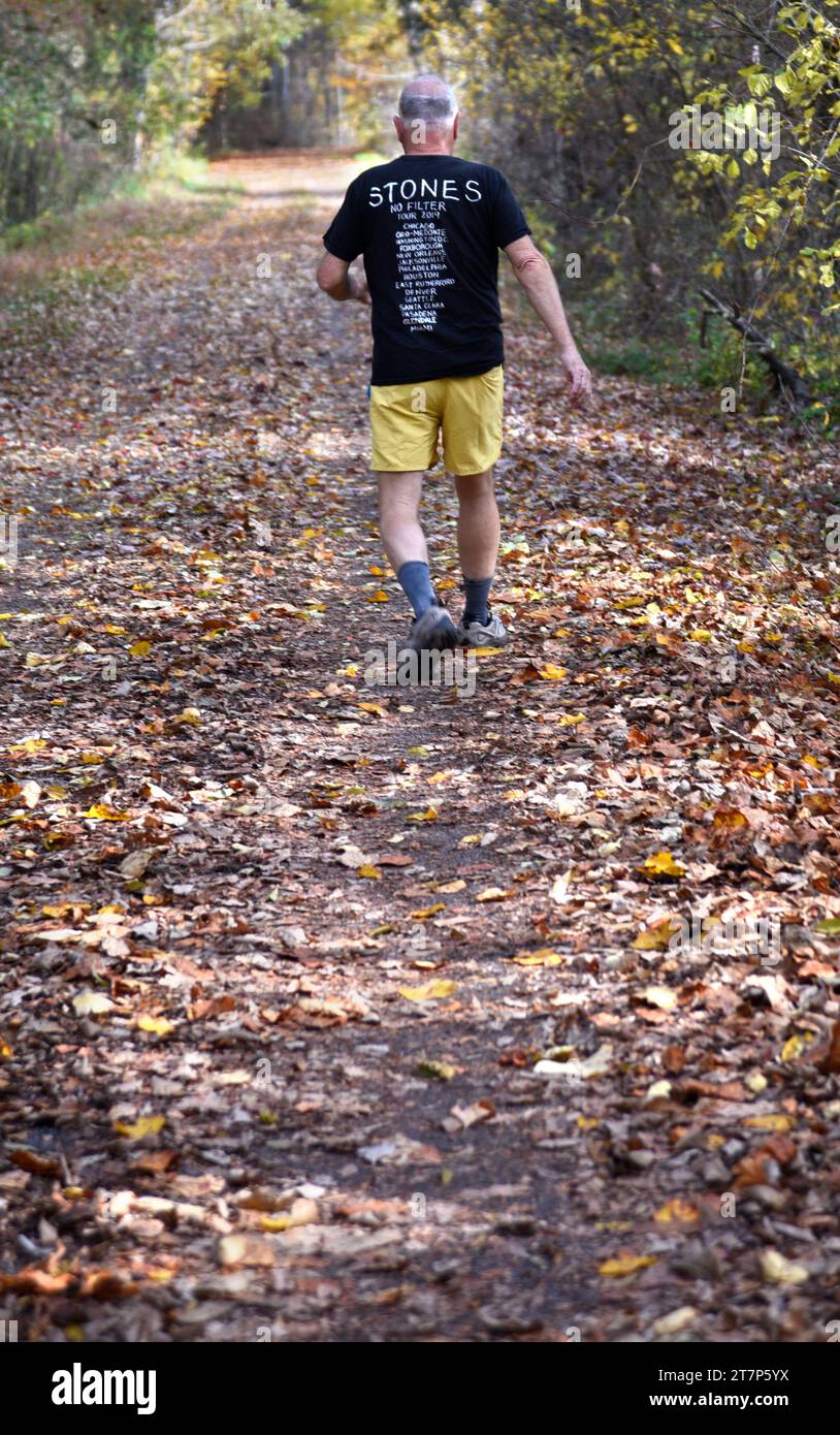 Ein älterer Mann, der ein T-Shirt von der Rolling Stones No Filter Tour 2019 trägt, läuft entlang des Virginia Creeper Trail in Abingdon, Virginia Stockfoto