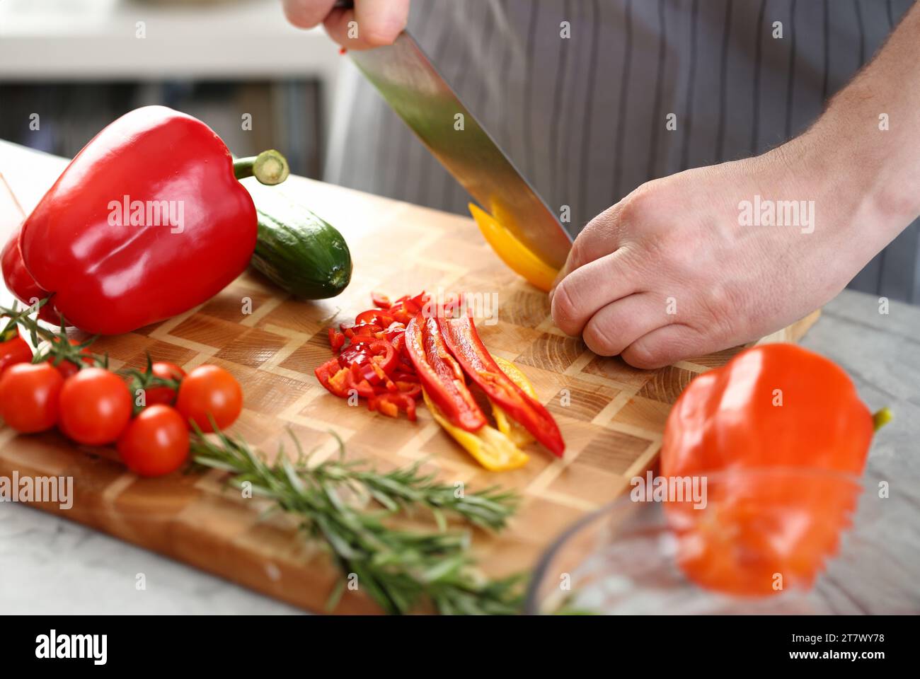 Männliche Hände Schneiden gelbe Paprika Salat Zutat Stockfoto