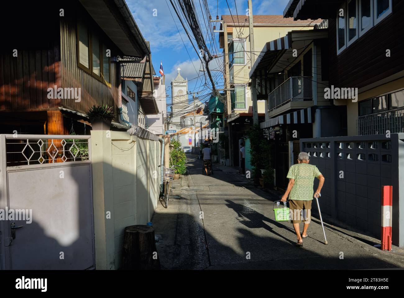 Ban Yuan, eine alte Siedlung vietnamesischer und kambodschanischer Einwanderer in Bangkok, Thailand; b/g: Die Unbefleckte Empfängnis-Kirche, Thailands erste Kirche Stockfoto