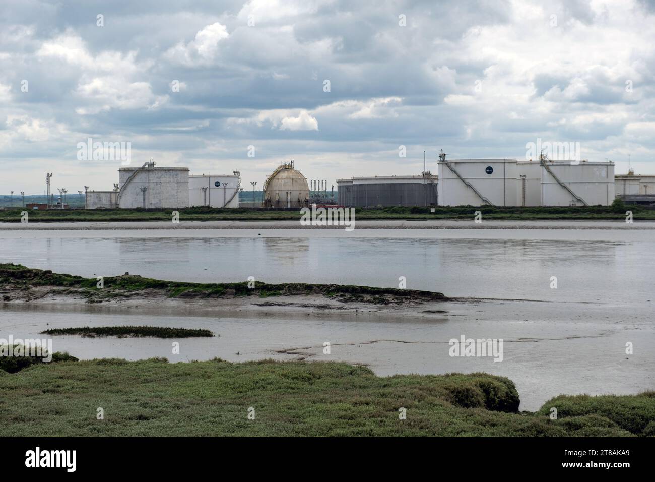 Blick auf den Fluss von Canvey Island über den Holehaven Creek in Richtung Coryton Oil Refinery (jetzt geschlossen). Öllagerbehälter Essex, England, Großbritannien 2023. Stockfoto