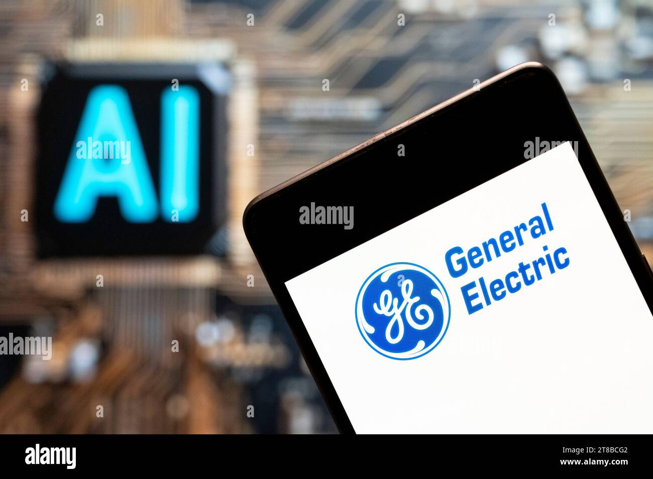 China. November 2023. In dieser Fotoabbildung ist das Logo der General Electric Company (GE, NYSE: GE) auf einem Smartphone mit einem Chip für künstliche Intelligenz (KI) und einem Symbol im Hintergrund zu sehen. Quelle: SOPA Images Limited/Alamy Live News Stockfoto