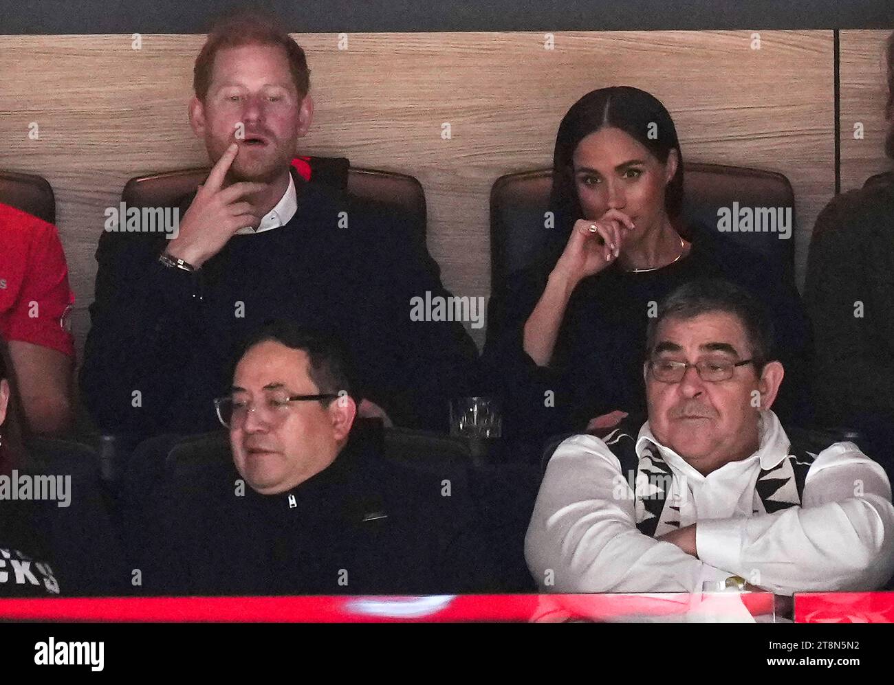 Prince Harry, top left, and Meghan Markle, top right, The Duke and Duchess of Sussex, watch the Vancouver Canucks and the San Jose Sharks play during the first period of an NHL hockey game in Vancouver, British Columbia, Monday, Nov. 20, 2023. (Darryl Dyck/The Canadian Press via AP) Stockfoto