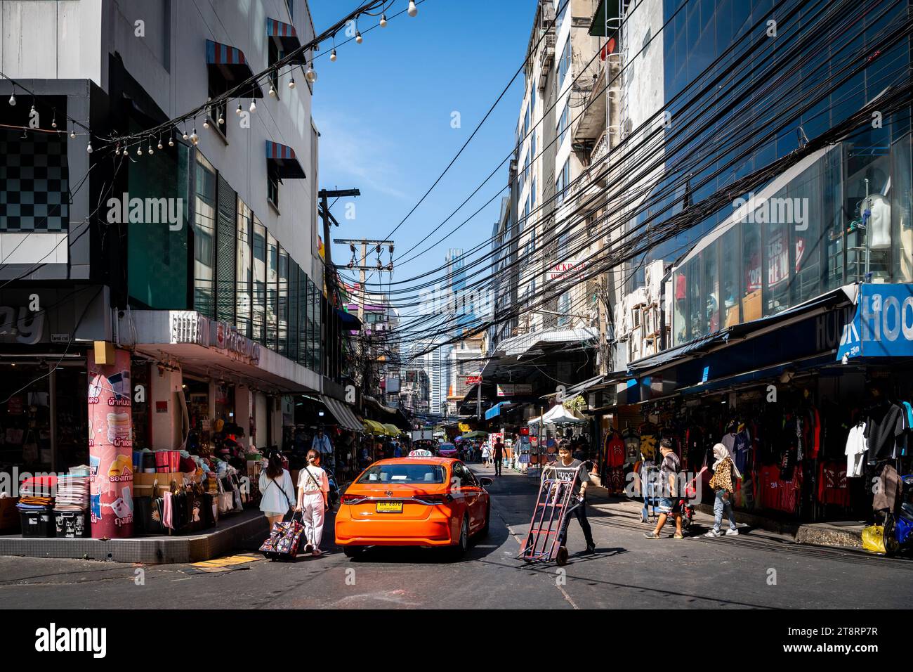 Ein Taxi fährt durch die geschäftigen Straßen von Pratunam Market, Bangkok, Thailand. Stockfoto