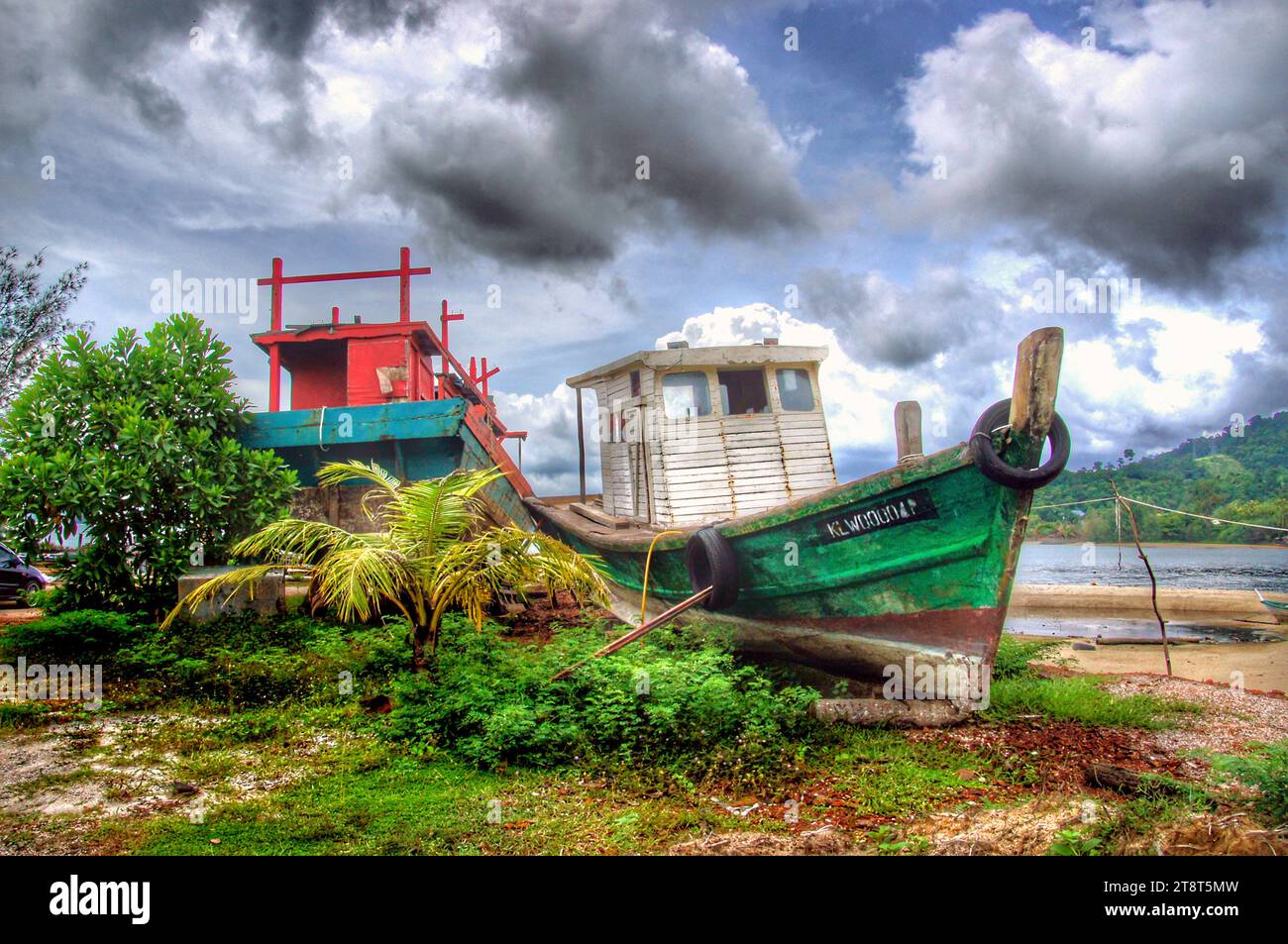 Das alte Boot Langkawi, Langkawi, offiziell bekannt als Langkawi, das Juwel von Kedah, ist ein Distrikt und ein Archipel von 99 Inseln in der Malakka-Straße. Etwa 30 km vor der Küste des Nordwestens Malaysias. Die Inseln sind Teil des Bundesstaates Kedah, der an die thailändische Grenze grenzt Stockfoto