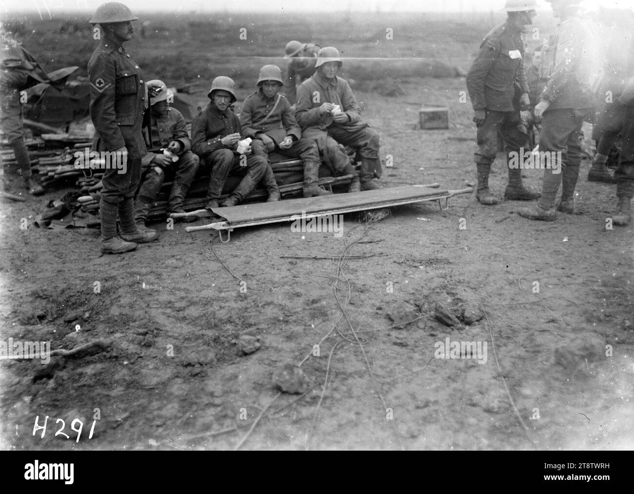 Gefangene deutscher Gefangener im Ersten Weltkrieg, Eine kleine Gruppe deutscher Gefangener, die am frühen Morgen mit neuseeländischen Soldaten in der Nähe saßen. Foto vom 4. Oktober 1917 Stockfoto