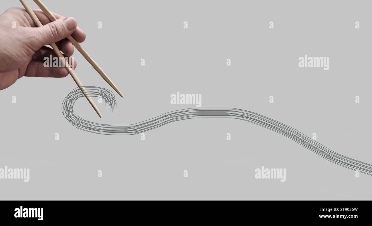 Asiatische Bambus-Essstäbchen in einer Hand auf monochromem Hintergrund gehalten. Kein Essen. Keine identifizierbare Person. Fotobearbeitung. Kopierbereich Stockfoto