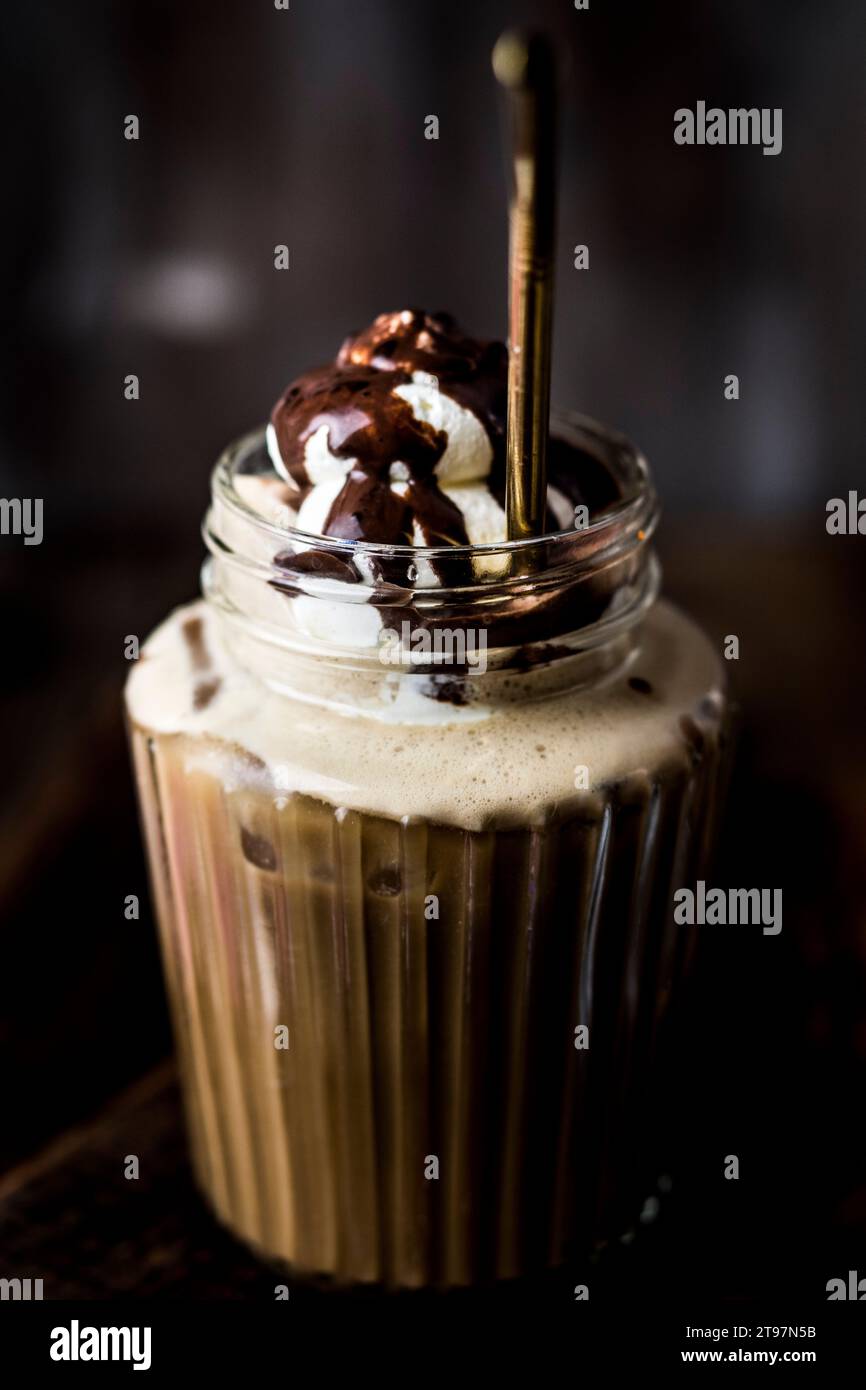 Tasse Eiskaffee mit Schlagsahne und Schokoladensauce Stockfoto