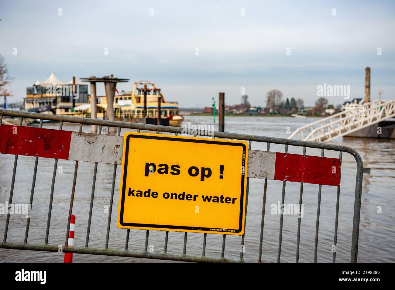 Nijmegen, Niederlande. November 2023. Vor einem überfluteten Bereich befindet sich ein Zaun mit einem Erwärmungsempfehlung. Die unteren Teile des Kais und rund um den Hafen an der Waalkade in Nijmegen liegen unter Wasser. Einige Nutztiere wurden in höhere Gebiete gebracht. Der Wasserstand liegt derzeit etwa 11 Meter über dem NAP (Normaal Amsterdams Peil). NICKERCHEN ist die Basis, um zu messen, wie hoch oder niedrig der Wasserstand ist. (Foto: Ana Fernandez/SOPA Images/SIPA USA) Credit: SIPA USA/Alamy Live News Stockfoto