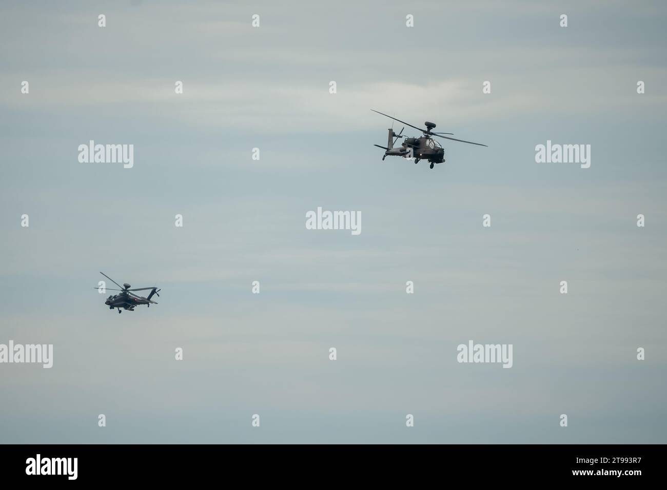 Ein Paar britische Armee Boeing Apache Angriffshubschrauber (AH-64E Army Air) im Tiefflug über die Sommerlandschaft Stockfoto