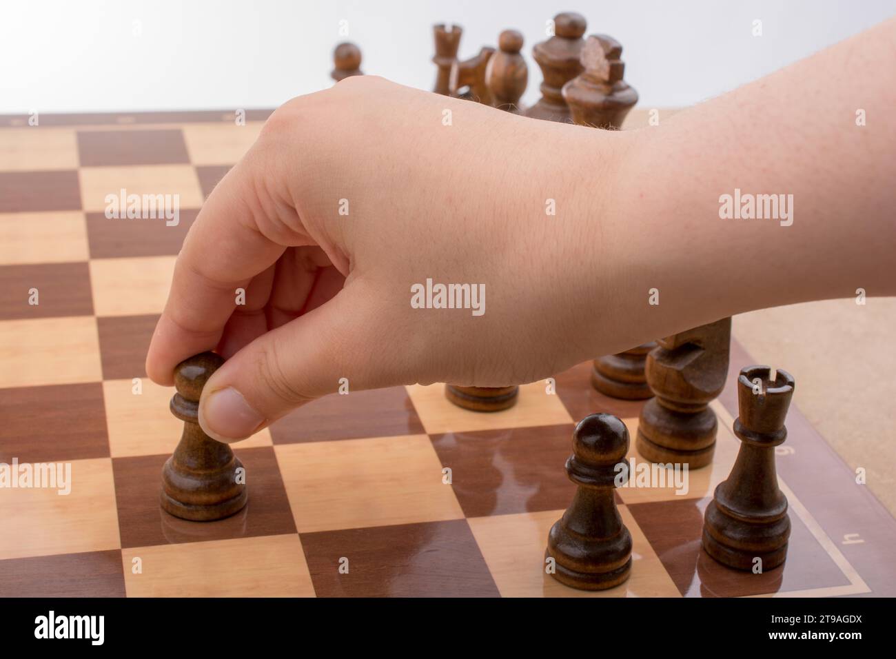 Person spielen Schach Spiel bewegt sich an Bord Stockfoto