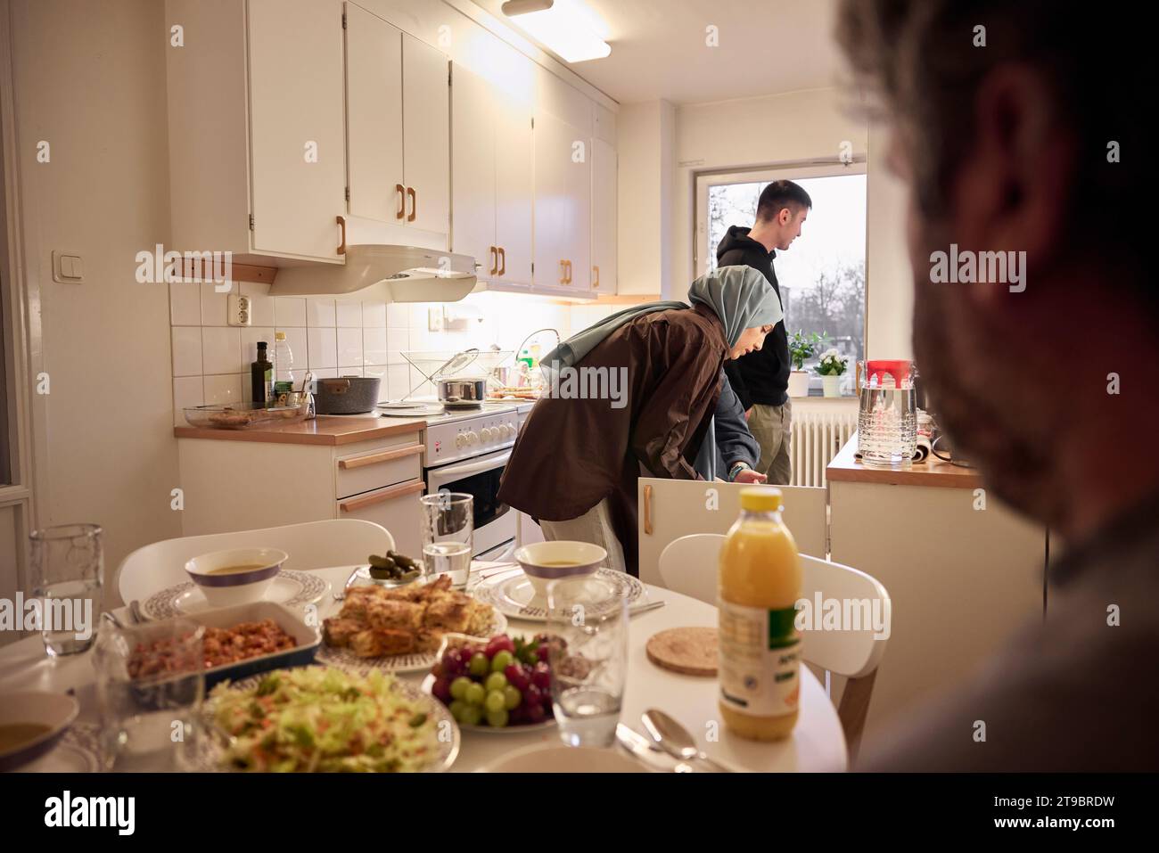 Die Familie bereitet zu Hause zusammen ein Abendessen vor Stockfoto