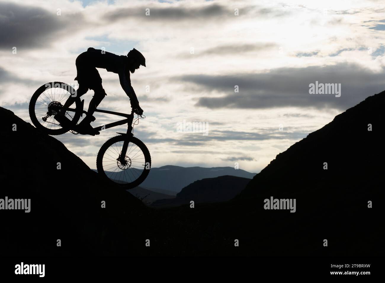 Silhouette Radfahrer, der auf Berg gegen Himmel fährt Stockfoto