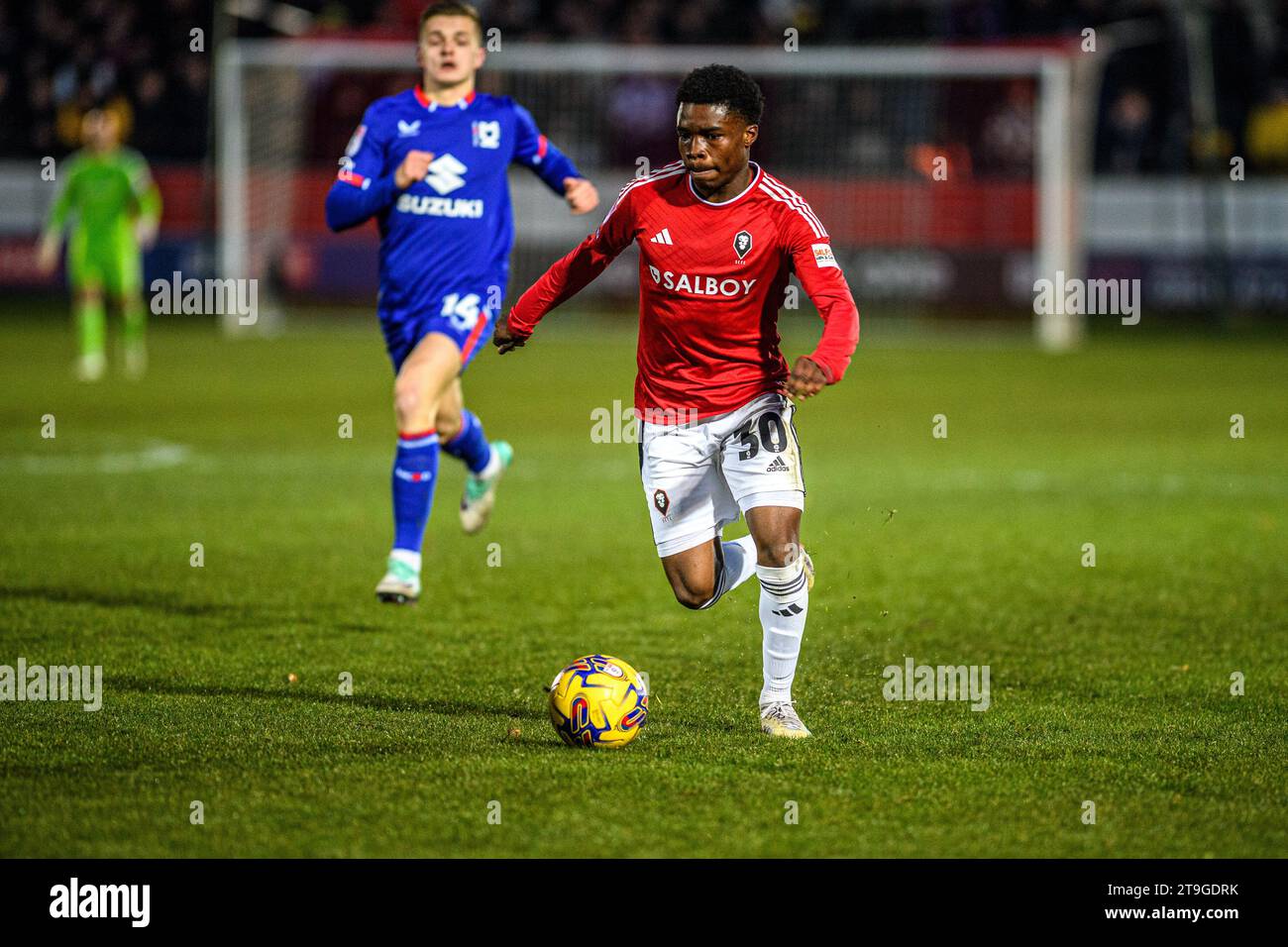 Kelly N'Mai von Salford City unter Druck von Joe Tomlinson, Milton Keynes, während des Spiels der Sky Bet League 2 zwischen Salford City und MK Dons im Peninsula Stadium, Moor Lane, Salford am Samstag, den 25. November 2023. (Foto: Ian Charles | MI News) Credit: MI News & Sport /Alamy Live News Stockfoto