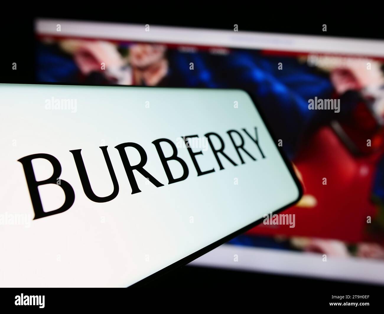 Handy mit Logo des britischen Luxusmodeunternehmens Burberry Group plc vor der Business-Website. Fokussieren Sie sich auf die linke Mitte des Telefondisplays. Stockfoto