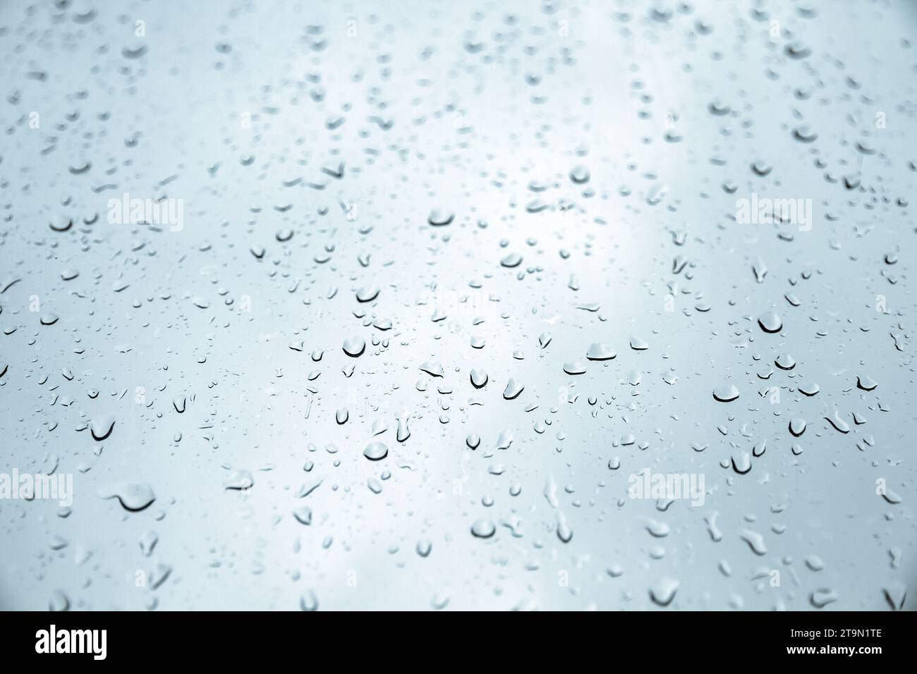 Regen fällt auf ein Fenster. Abstraktes Hintergrundbild Stockfoto