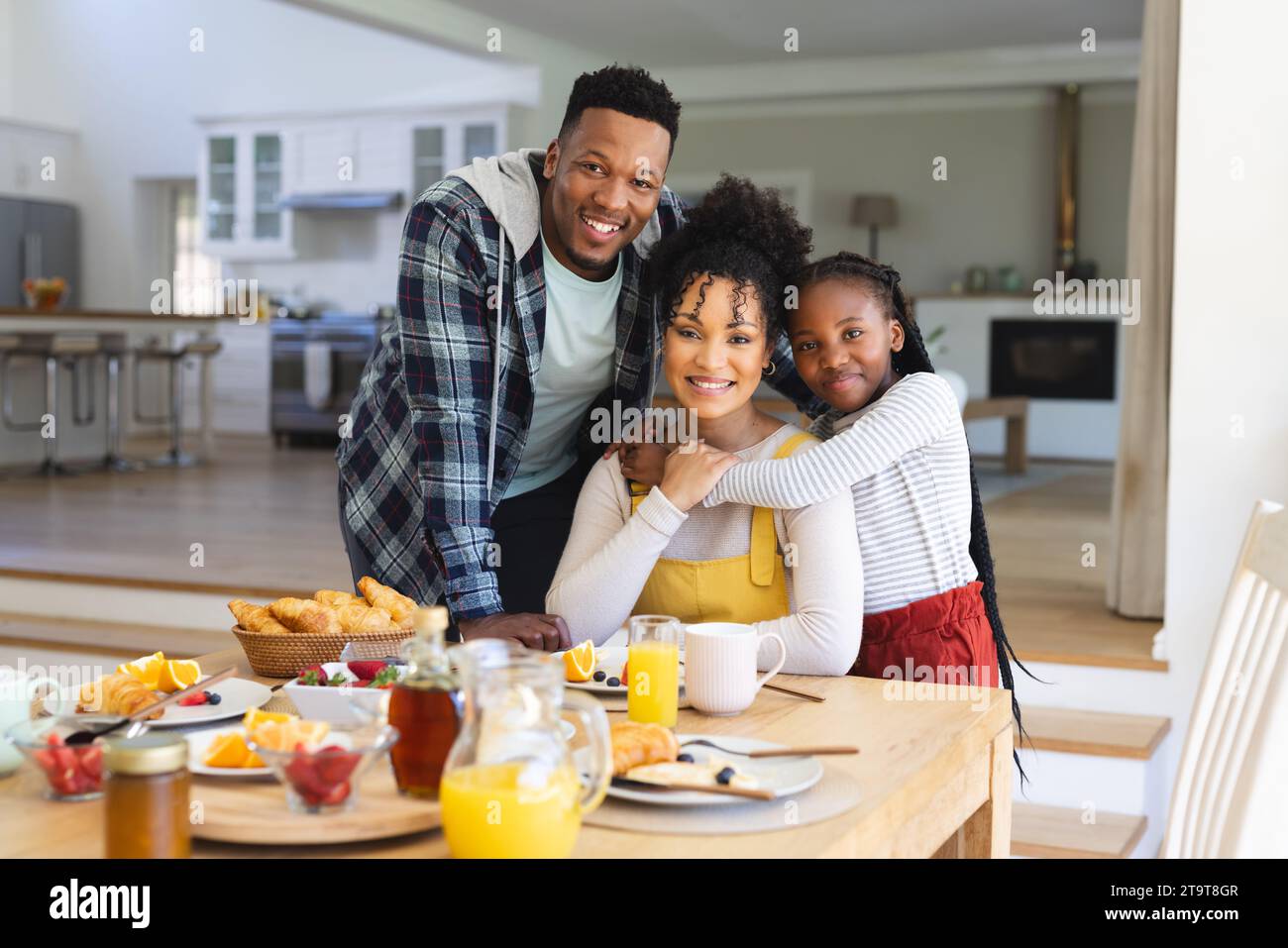 Porträt einer glücklichen afroamerikanischen Familie, die sich am Tisch im Esszimmer zu Hause umschließt, Kopierraum. Miteinander, Elternschaft, Kindheit, Essen und Trinken, Stockfoto