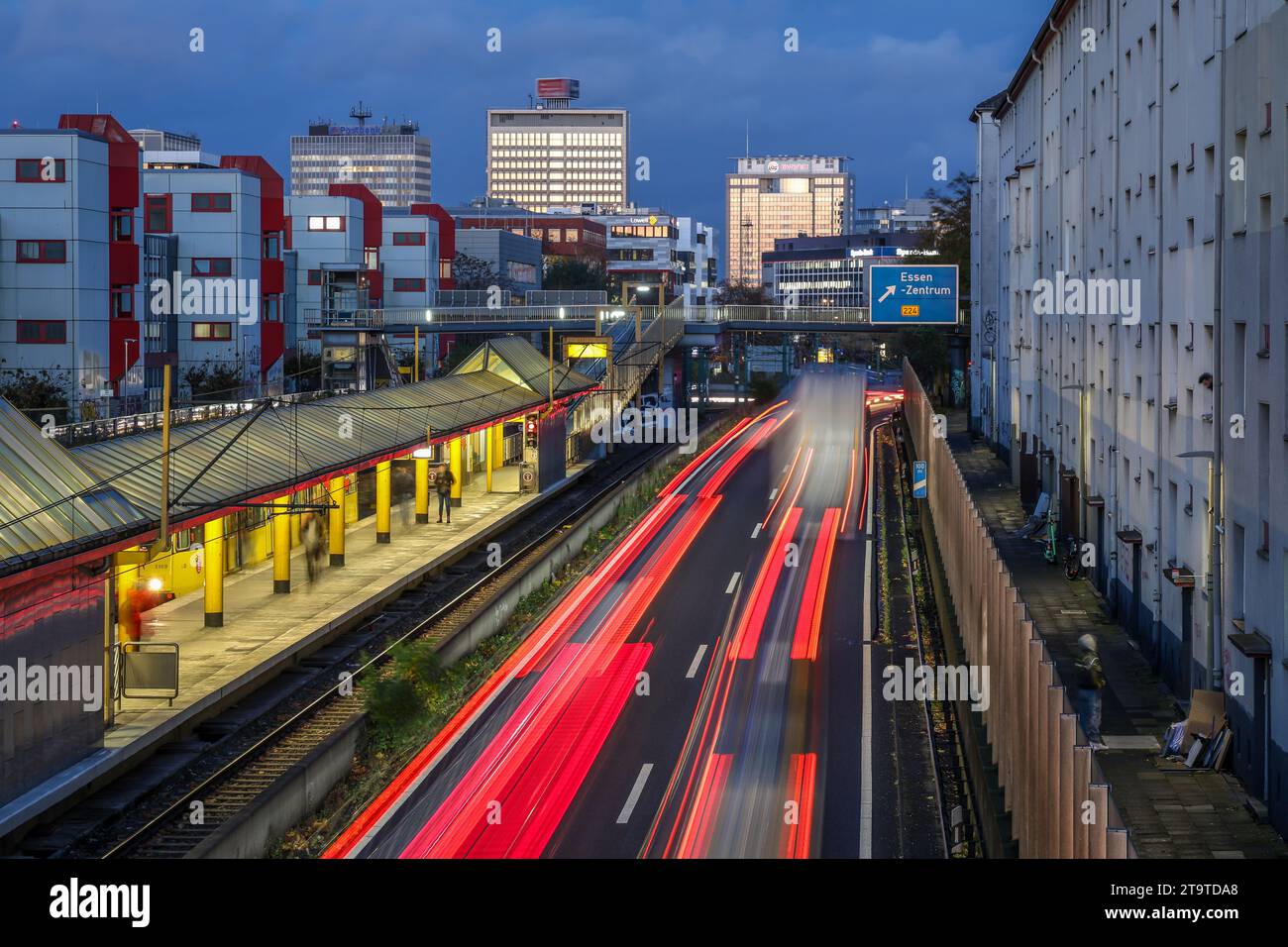 Essen, Nordrhein-Westfalen, Deutschland - Autobahn A40 im Stadtzentrum, Ausfahrt Essen Zentrum, in der Abenddämmerung. Leute, die am Savignystrass warten Stockfoto