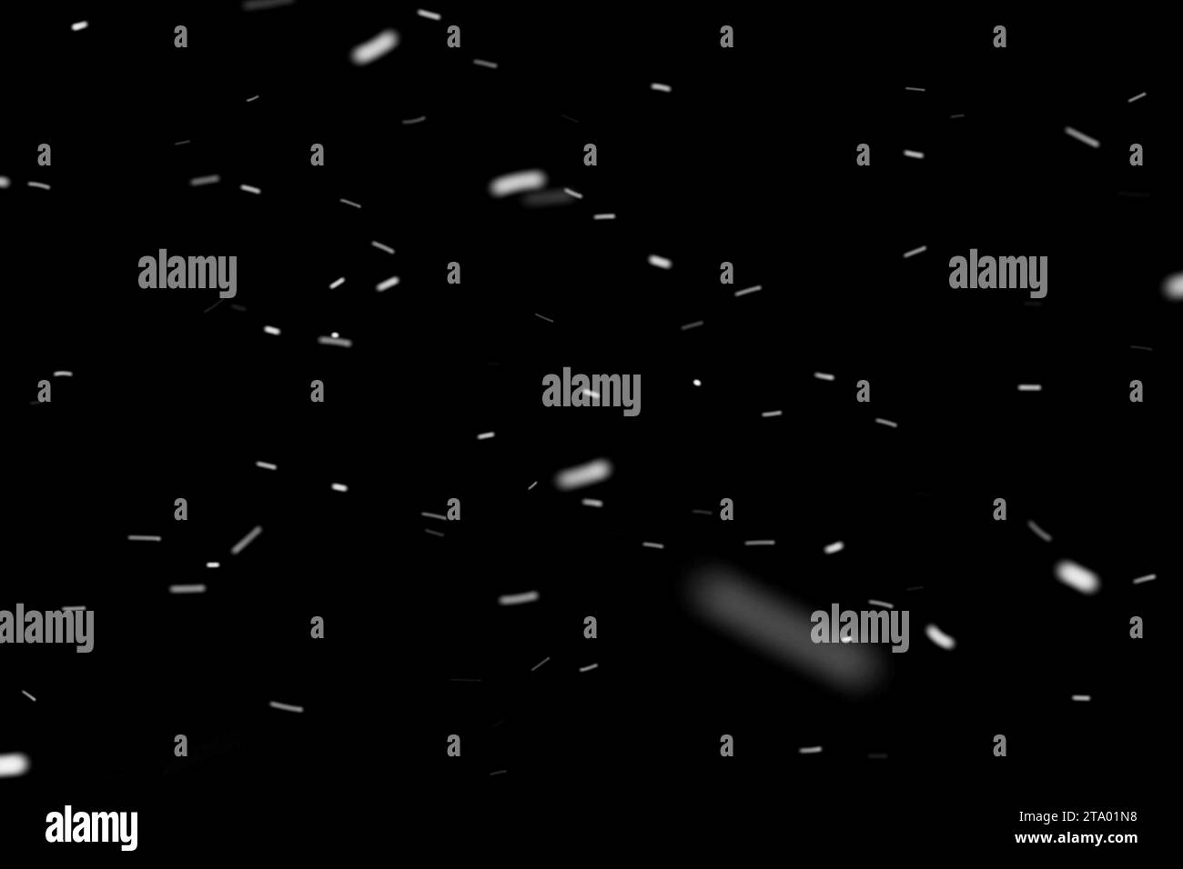 Abstrakte Staubpartikel auf dunklem Hintergrund mit Lichtfleck Stockfoto
