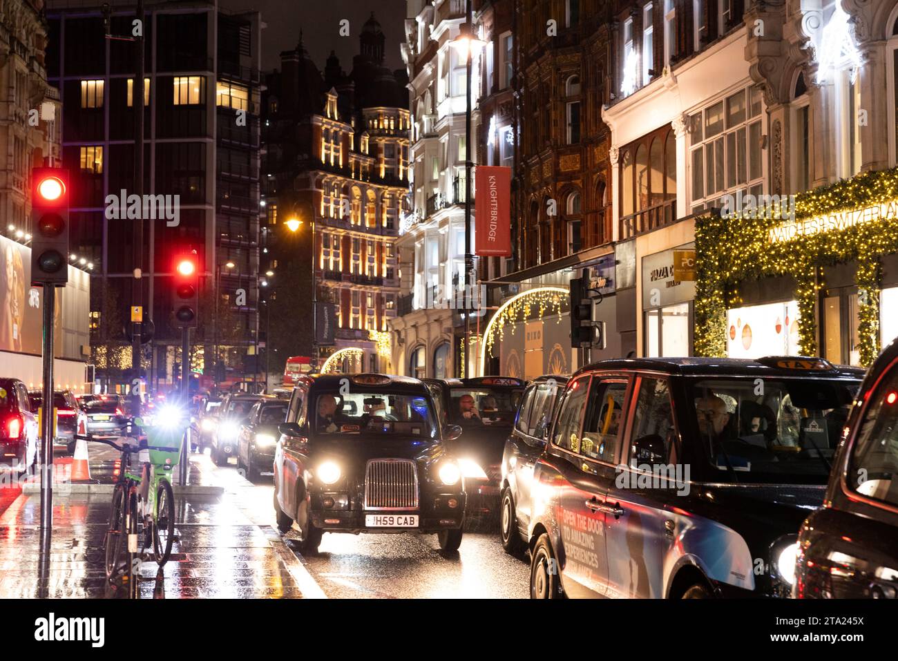 Knightsbridge eine der luxuriösesten Gegenden Londons an einem nassen Abend während der Hauptverkehrszeit, Londons West End, England, Vereinigtes Königreich Stockfoto
