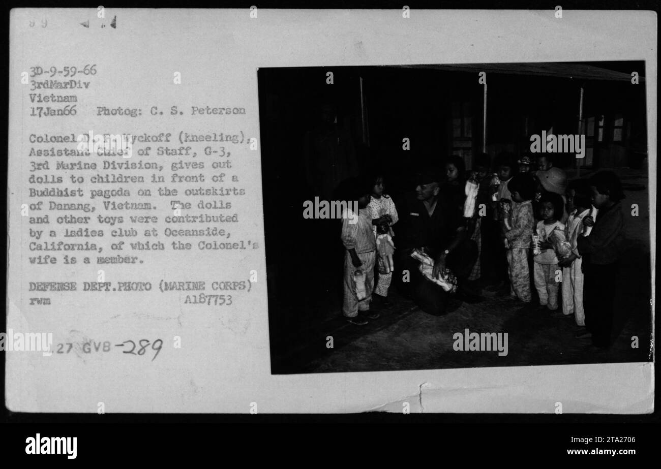 Colonel D. P. Wyckoff von der 3. Marine Division in Vietnam verteilt am 17. Januar 1966 vor einer buddhistischen Pagode in der Nähe von Danang Puppen an Kinder. Das Spielzeug wurde vom Ladies Club in Oceanside, Kalifornien, gespendet, wo die Frau des Colonels Mitglied ist. Dieses Foto zeigt eine persönliche Interaktion während des Vietnamkriegs. Stockfoto