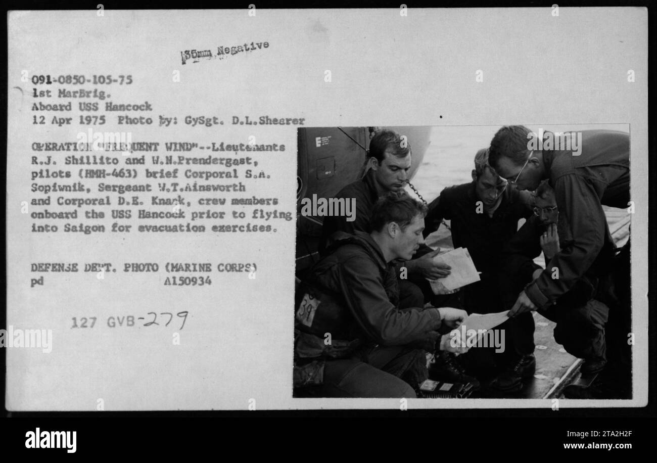 Lieutenants R.J. Shillito und W.N. Prendergast, Piloten von HMH-463, Brief Corporal S.A. Sopiwnik, Sergeant V.T. Ainsworth und Corporal D.E. Knaak, Besatzungsmitglieder an Bord der USS Hancock. Dieses Briefing wurde vor ihrer Mission durchgeführt, Saigon für Evakuierungsübungen im Rahmen der Operation Frequent Wind am 12. April 1975 zu erreichen. Das Foto wurde von GySgt aufgenommen. D.L. Shearer. Stockfoto