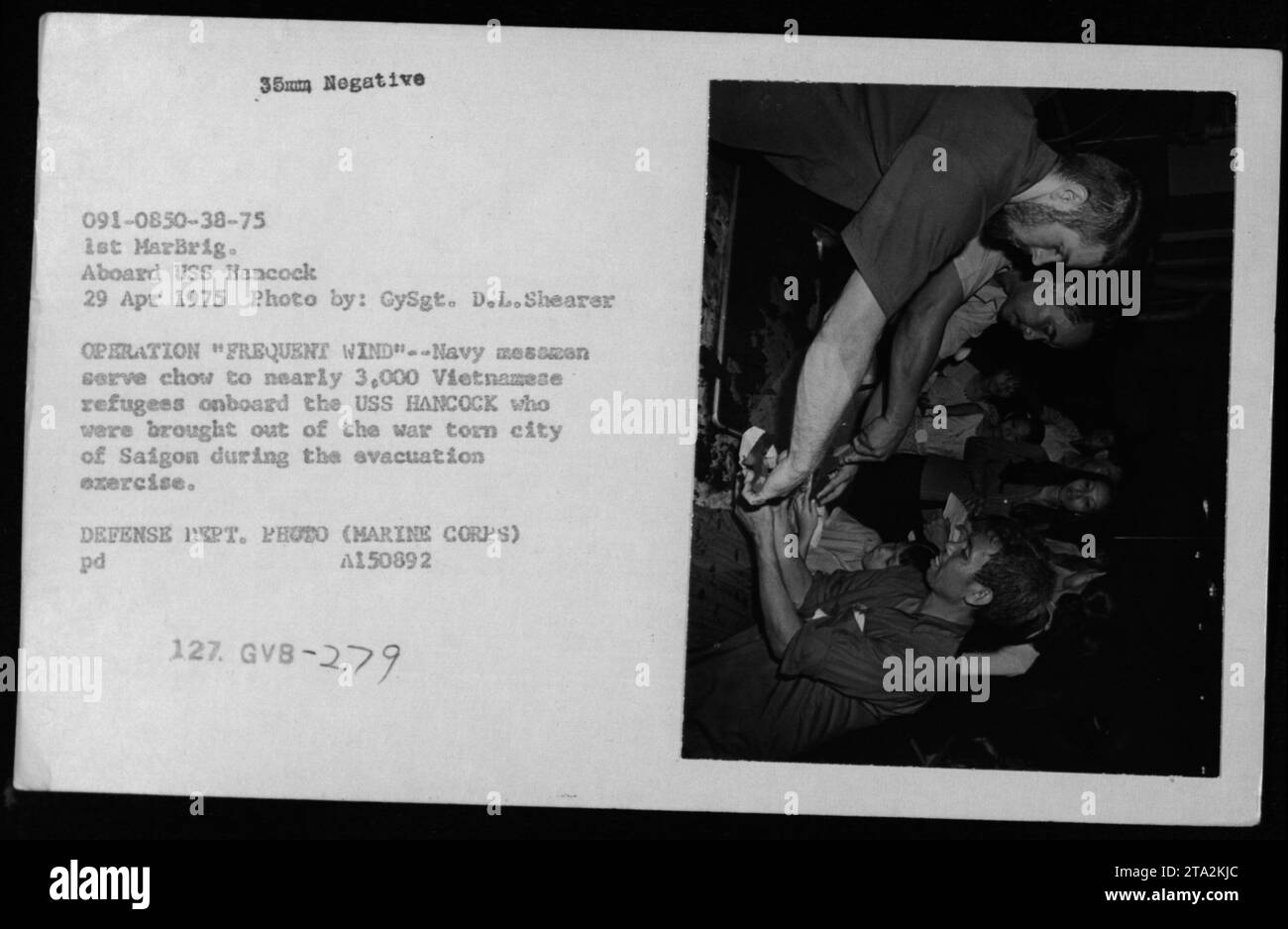 Während der Operation Frequent Wind Evakuation aus Saigon, 1975, servieren Marinemachleute rund 3.000 vietnamesische Flüchtlinge an Bord der USS Hancock Mahlzeiten. Stockfoto