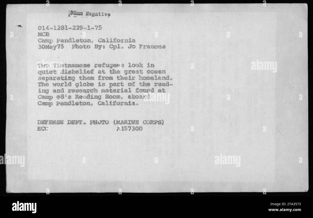 Zwei vietnamesische Flüchtlinge in Camp Pendleton, Kalifornien, blicken auf den Ozean, der sie von ihrer Heimat trennt. Das Foto, aufgenommen am 30. Mai 1975, zeigt eine Weltkugel, die Teil des Lesematerials von Camp 8 ist. Foto von CPL. Jo Frances, Verteidigungsministerium (Marine Corps). Stockfoto
