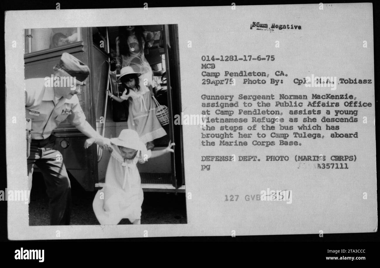 Ein vietnamesischer Flüchtling kommt am 29. April 1975 in Camp Tulega, Marine Corps Base Pendleton, Kalifornien an, unterstützt von Gunnery Sergeant Norman MacKenzie und zeigt, dass das Marine Corps während des Vietnamkriegs Flüchtlingshilfe leistet. Stockfoto
