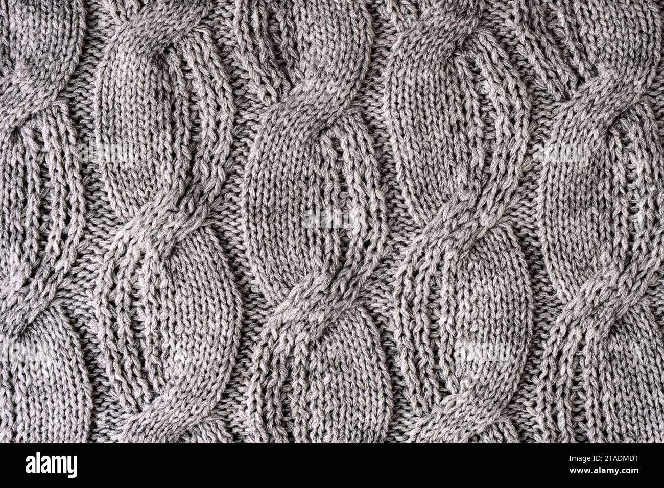 Grauer Wollstrick-Pullover, Textur, Hintergrund. Stockfoto