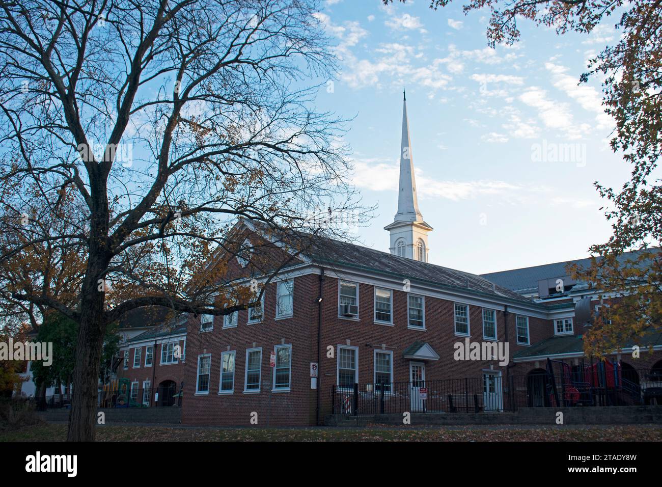 Weißer Kirchturm, der in einen teilweise bewölkten blauen Himmel ragt, in Westfield, New Jersey -01 Stockfoto